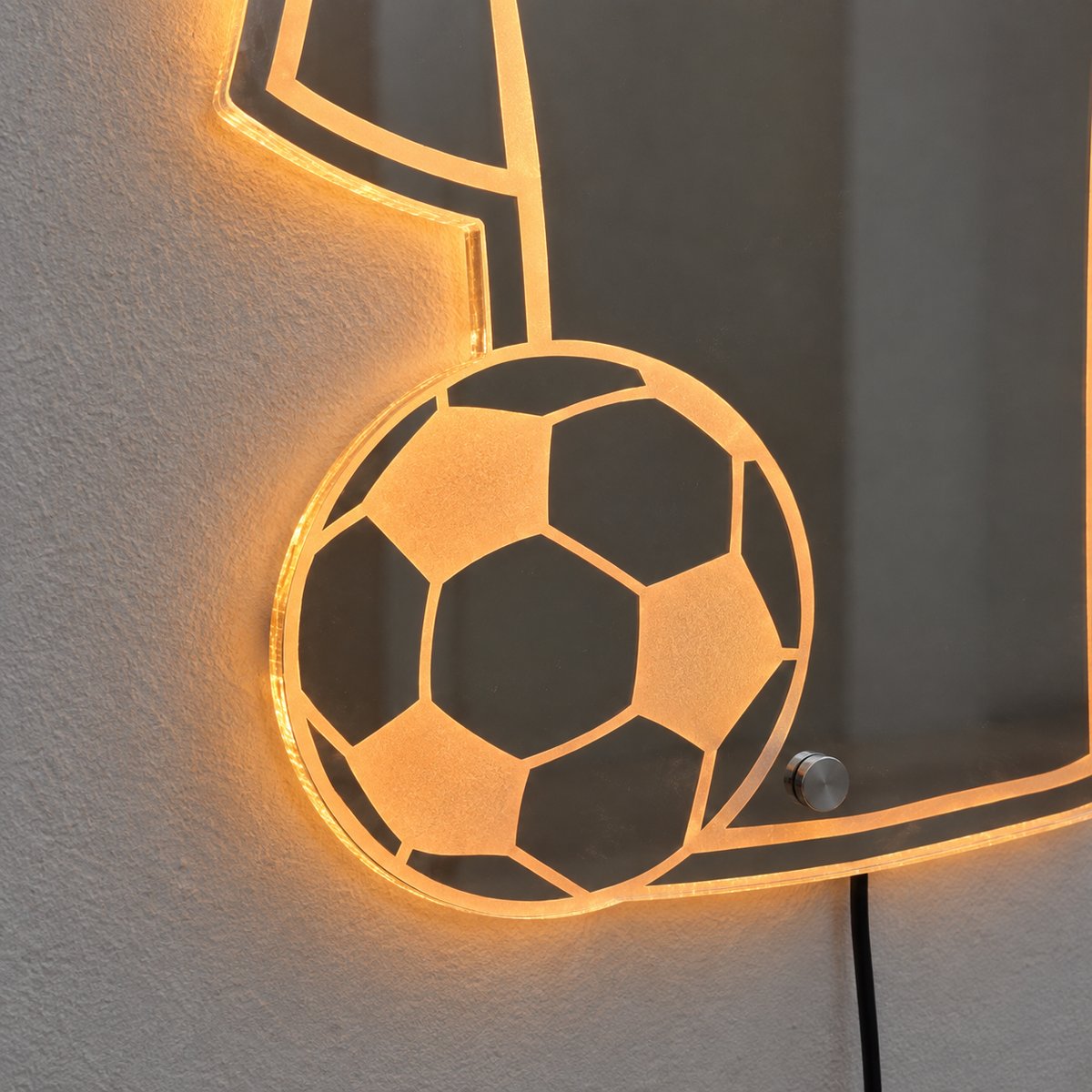 Close-up of the etched soccer ball and the glowing acrylic edge of the jersey mirror