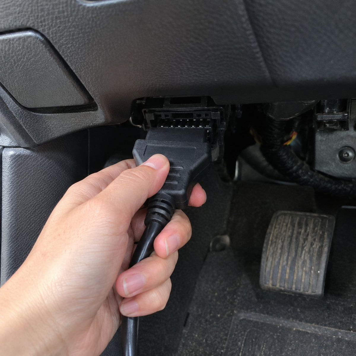 Plugging the OBD power cable under the dashboard