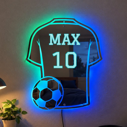 Custom jersey LED mirror with the name MAX and number 10 glowing blue and teal on a bedroom wall