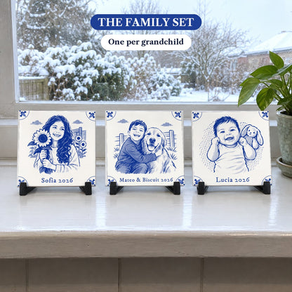 The Family Set: three square Delft-blue photo tiles on a snowy windowsill: a girl with a sunflower, a boy hugging his dog and a smiling baby