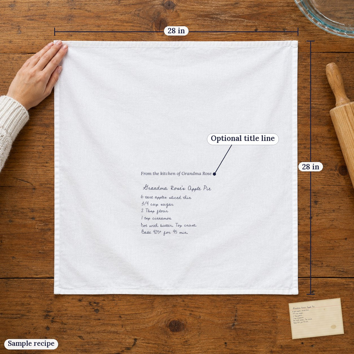 The 28 x 28 in white cotton towel laid flat with the recipe and an optional title line (sample recipe)
