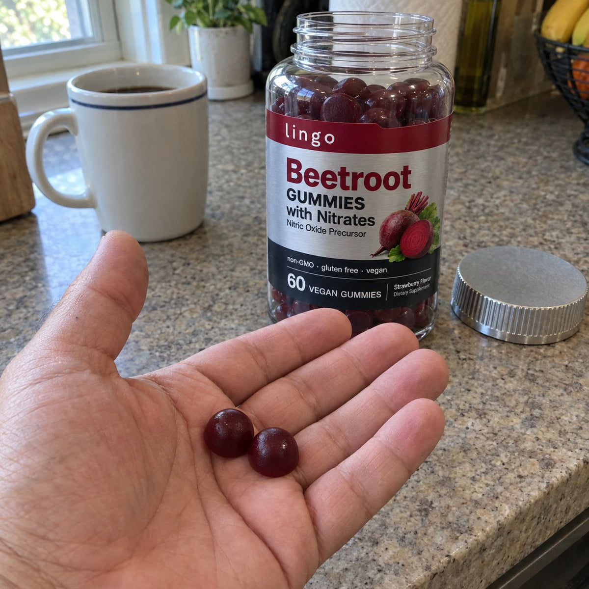 Two beetroot gummies in the palm, the jar behind