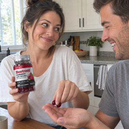 She hands him two beetroot gummies in the kitchen