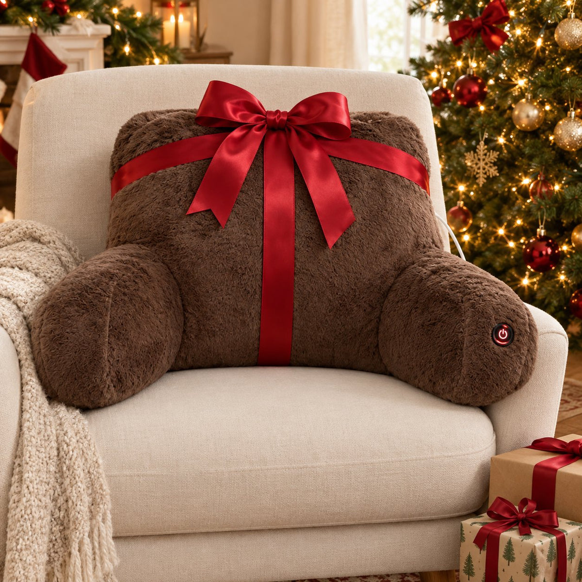Heated backrest pillow tied with a red ribbon next to a Christmas tree