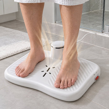 Wet bare feet standing on the body dryer in a bathroom while warm air rises around the ankles