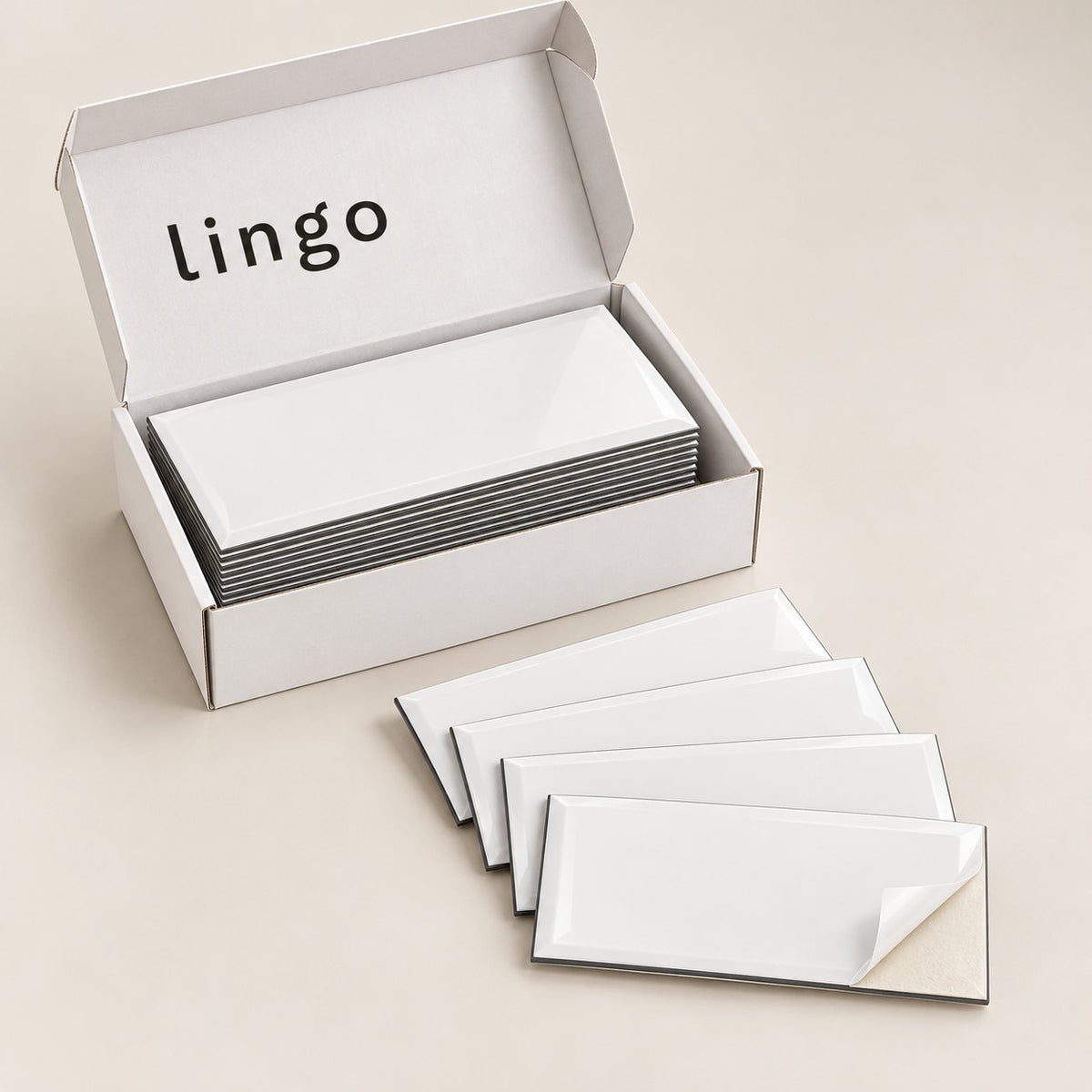 The lingo box of white subway tiles, a few loose tiles fanned out