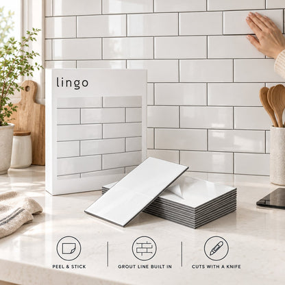 Peel and stick white subway tiles on a kitchen backsplash, with the lingo box: peel and stick, grout line built in, cuts with a knife