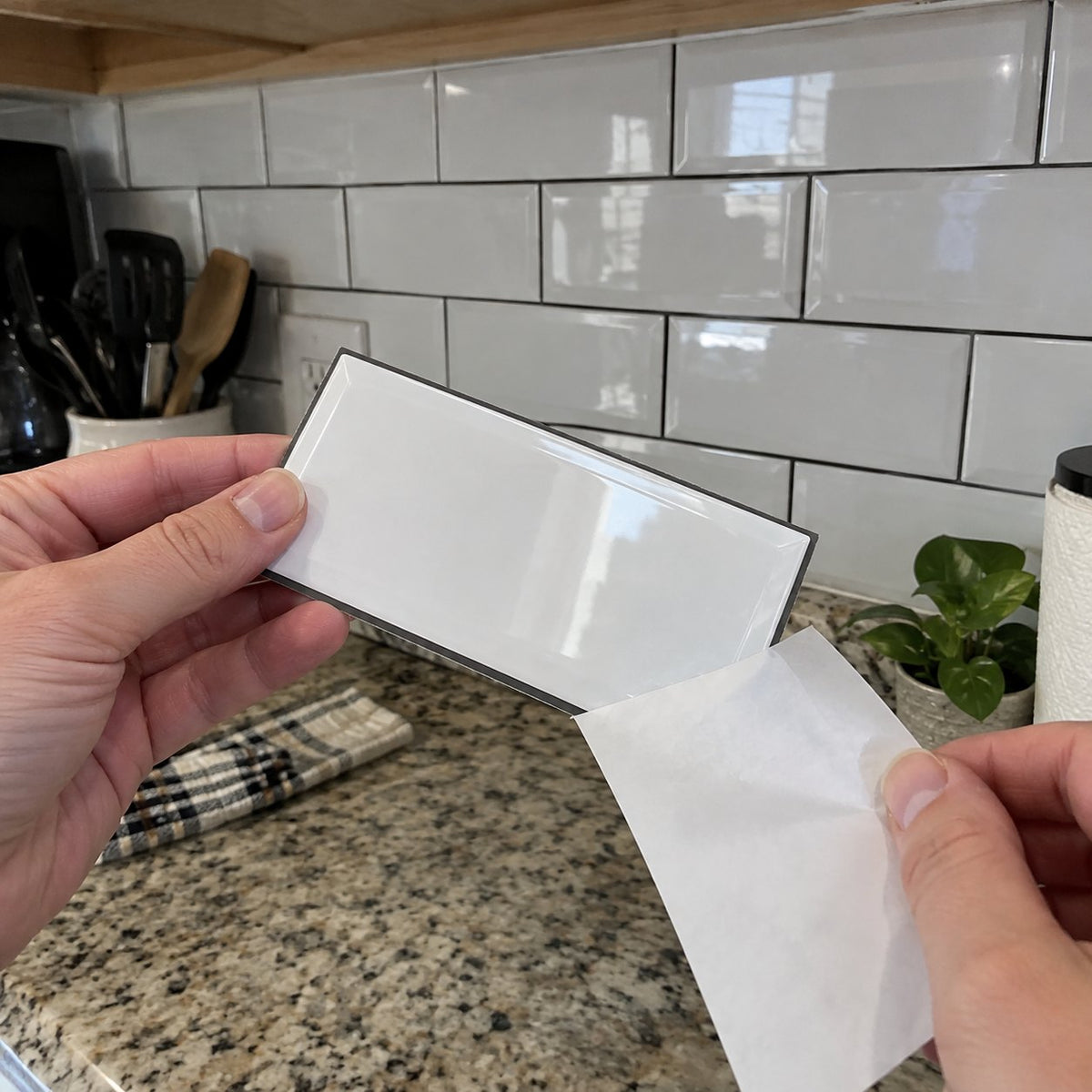 Peeling the backing off a tile