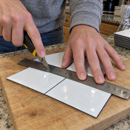 Cutting a tile with a utility knife
