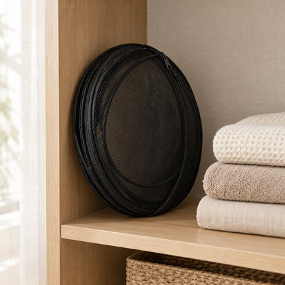 The playpen folded flat on a closet shelf