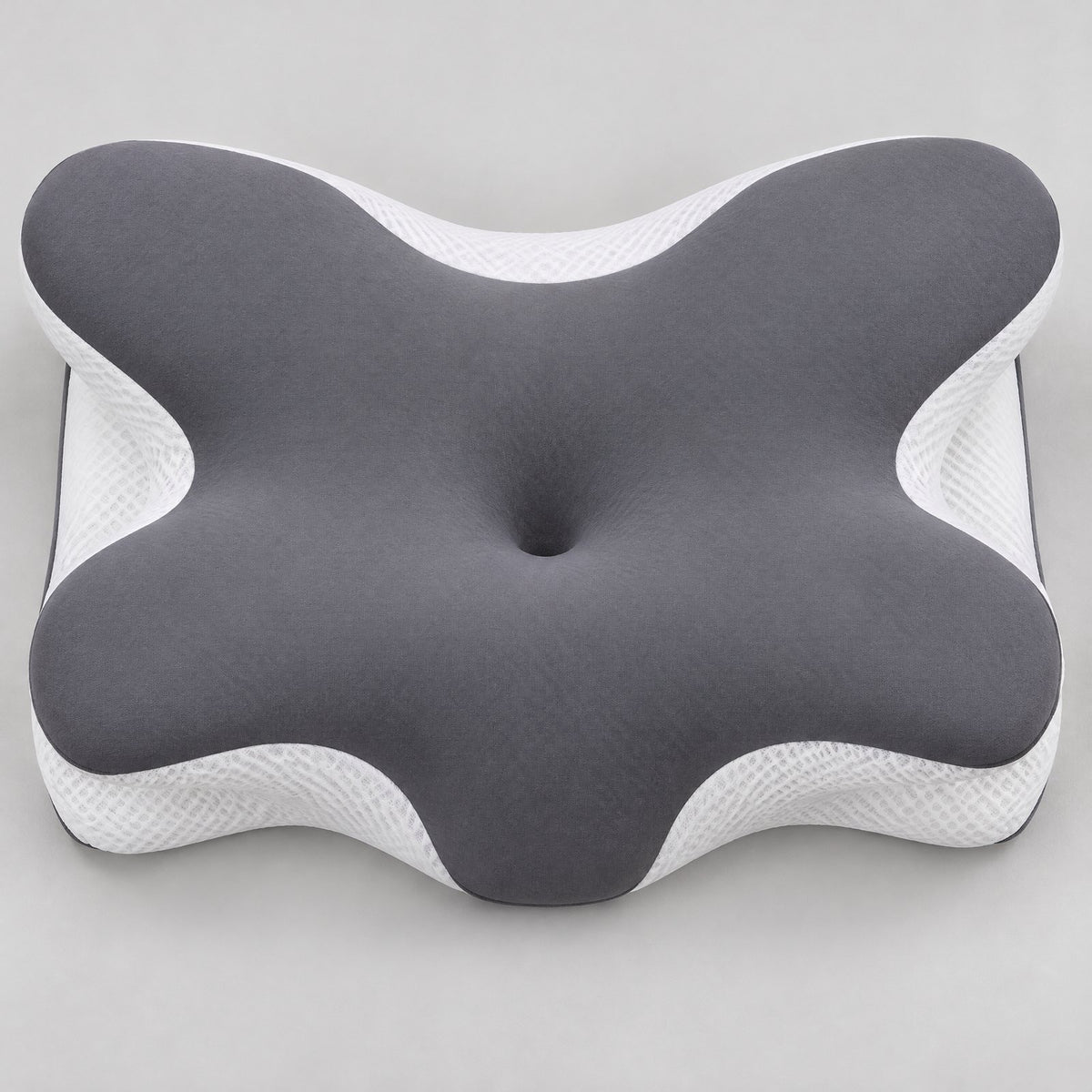 Top view of the butterfly-shaped contour pillow: center hollow, side wings, neck edge