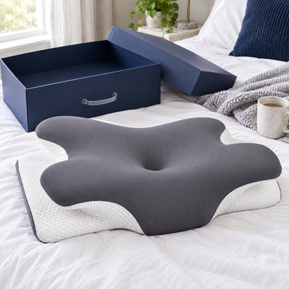 The contour pillow on a bed next to a navy box