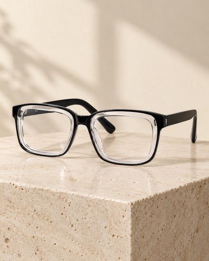 Progressive photochromic reading glasses, Black & Clear frame, on a travertine stone