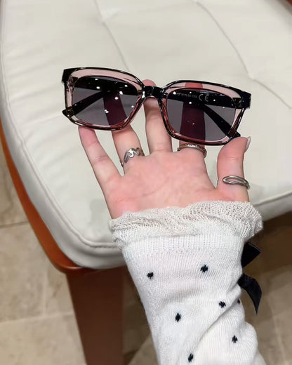 The glasses with tinted lenses held in a hand, real photo