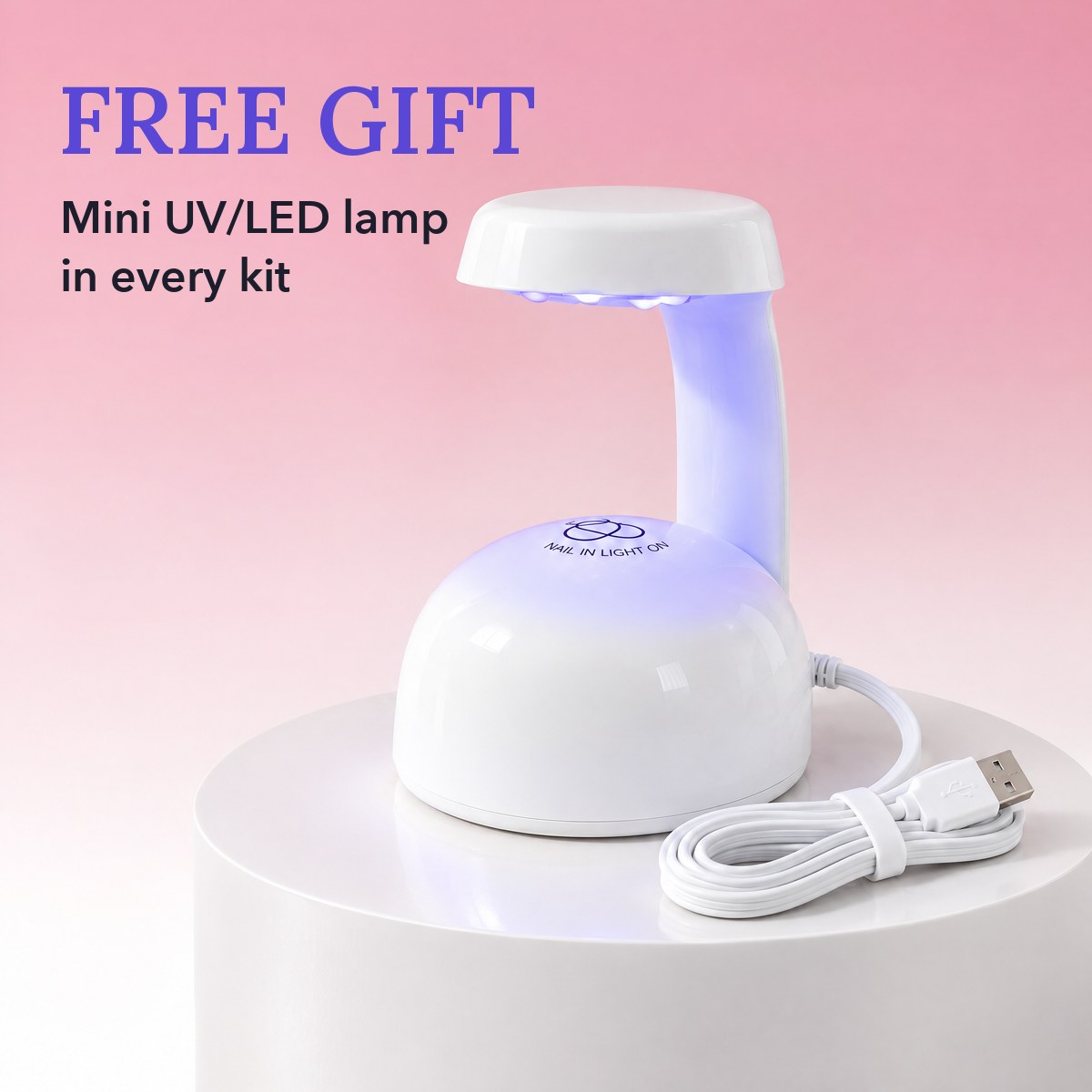 The free mini UV/LED lamp, lit, on a white podium with its flat USB cable