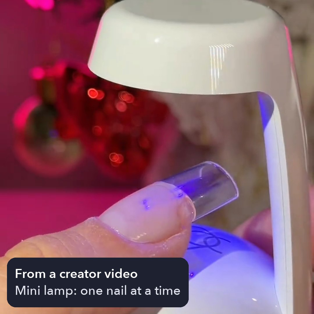Creator curing one nail under the mini lamp