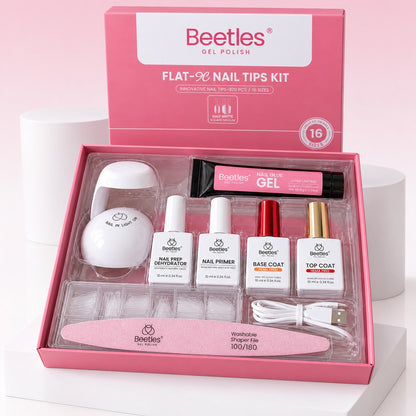 The pink kit box open, with the lamp, bottles, glue gel tube, tips case, cable and file inside