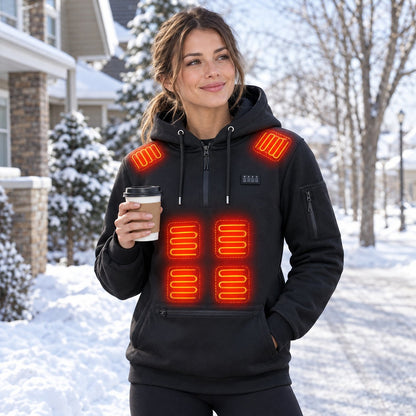 Woman wearing the heated hoodie with a coffee on a snowy street, heating zones glowing on her shoulders and belly