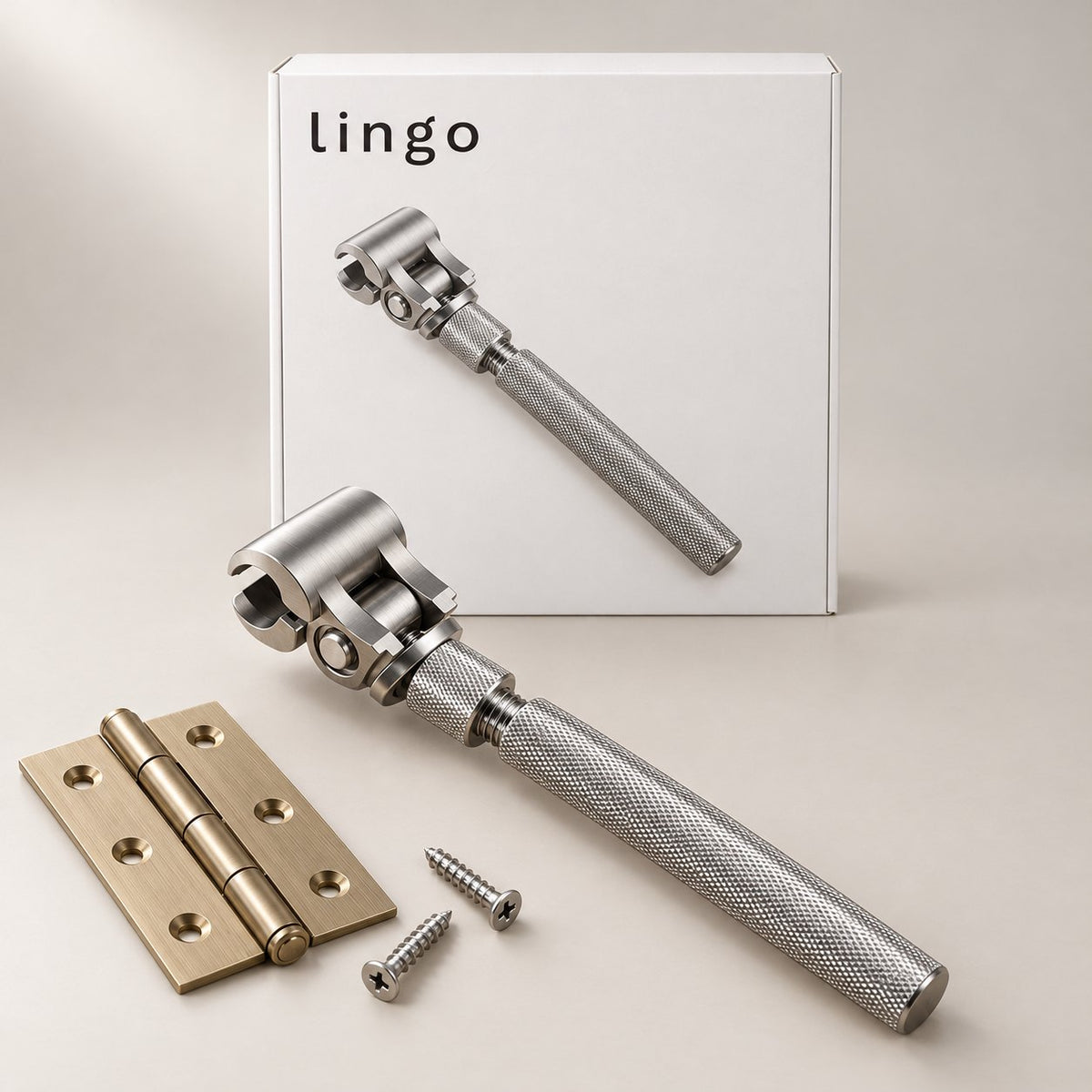 Stainless hinge wrench next to a brass hinge and its lingo box