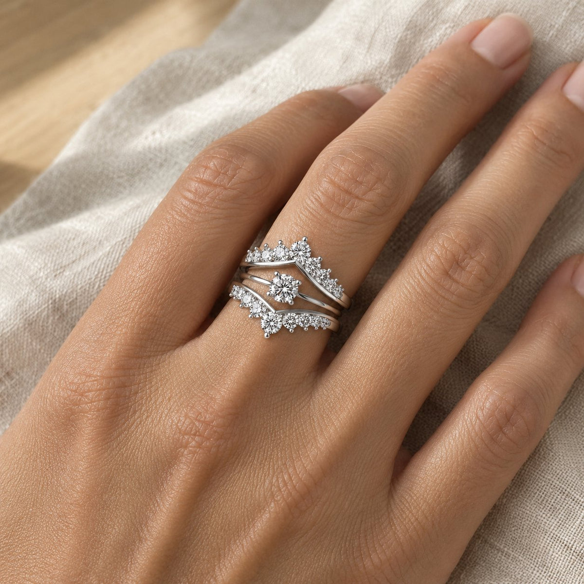 Silver ring jacket protecting an engagement ring on both sides