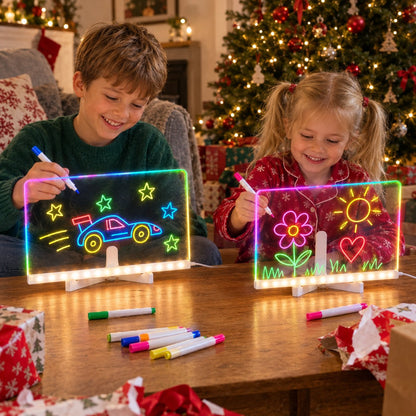 Brother and sister on Christmas morning, each drawing on their own glowing LED board