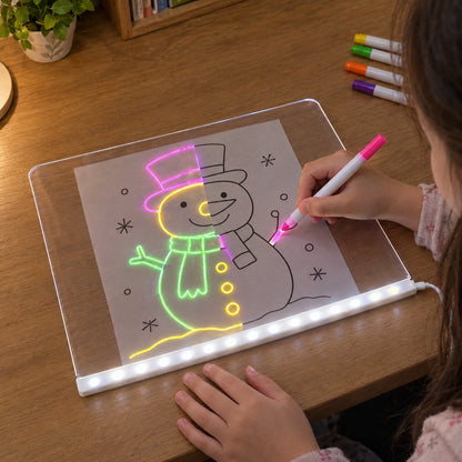 Child tracing a snowman coloring page through the clear LED board with neon markers