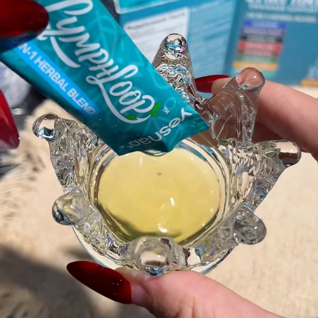 Hand squeezing a LymphLoop liquid stick into a small glass bowl