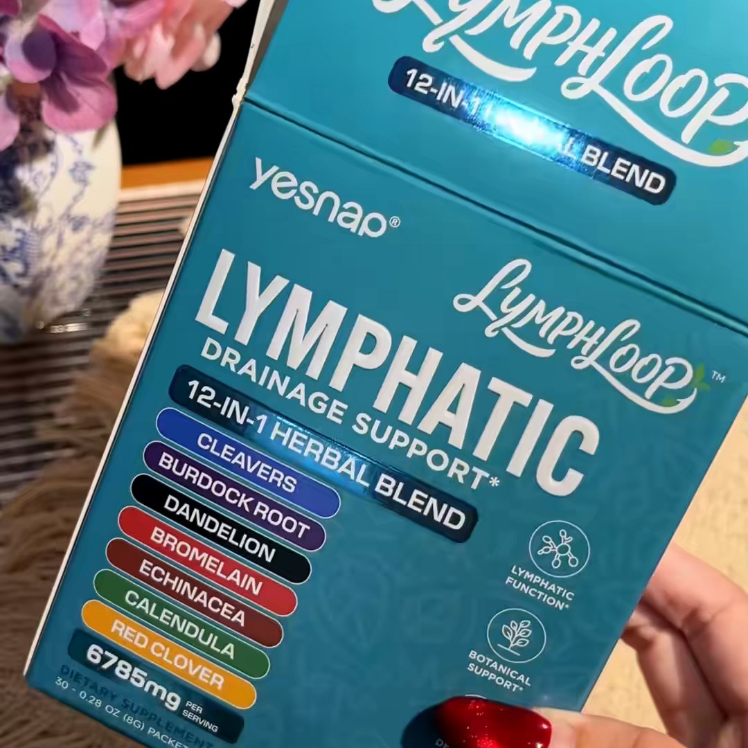 Hand holding the YESNAP LymphLoop box with the list of herbs