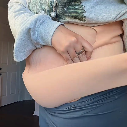 Close-up of a woman closing the nude band under her bump