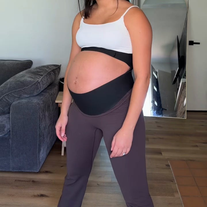 Pregnant woman wearing the black support band, with the lift band under the bump and the top band above it