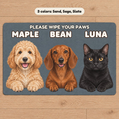 A slate doormat with a goldendoodle, a dachshund and a black cat named Maple, Bean and Luna under the words Please wipe your paws