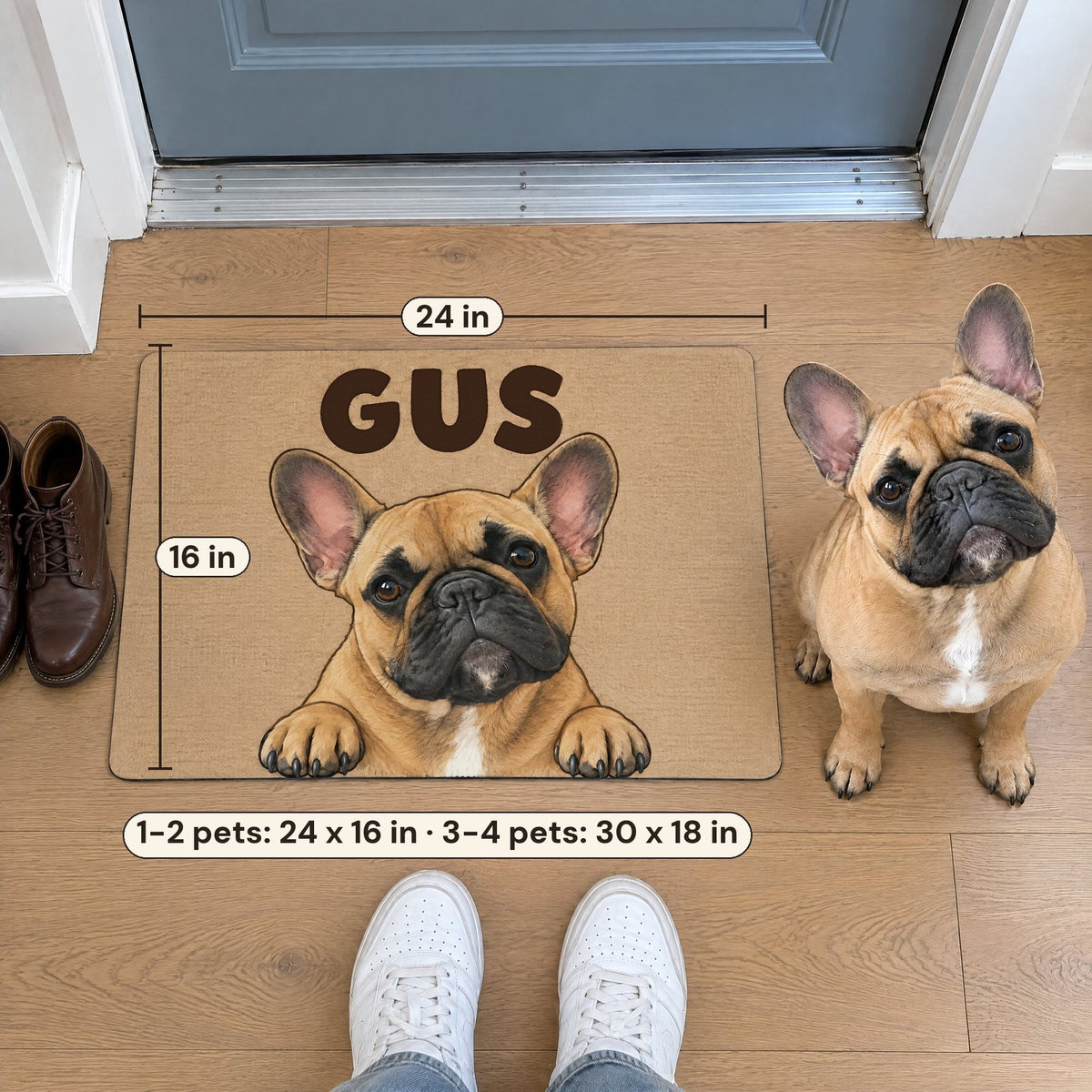 A 24 by 16 inch doormat with a French bulldog named Gus in an apartment entry, the real dog beside it and sneakers for scale
