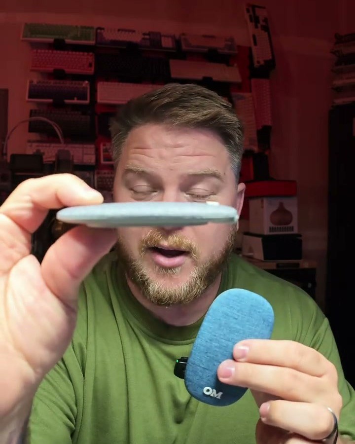 Creator holding the speaker edge-on to show how thin it is, frame from his video