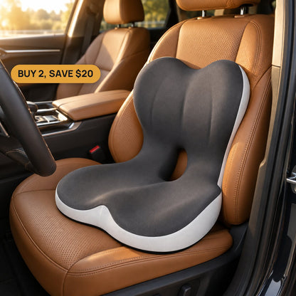 Charcoal-grey butterfly seat cushion with white side band, two-lobe lumbar backrest and open tailbone slot on a tan leather car seat