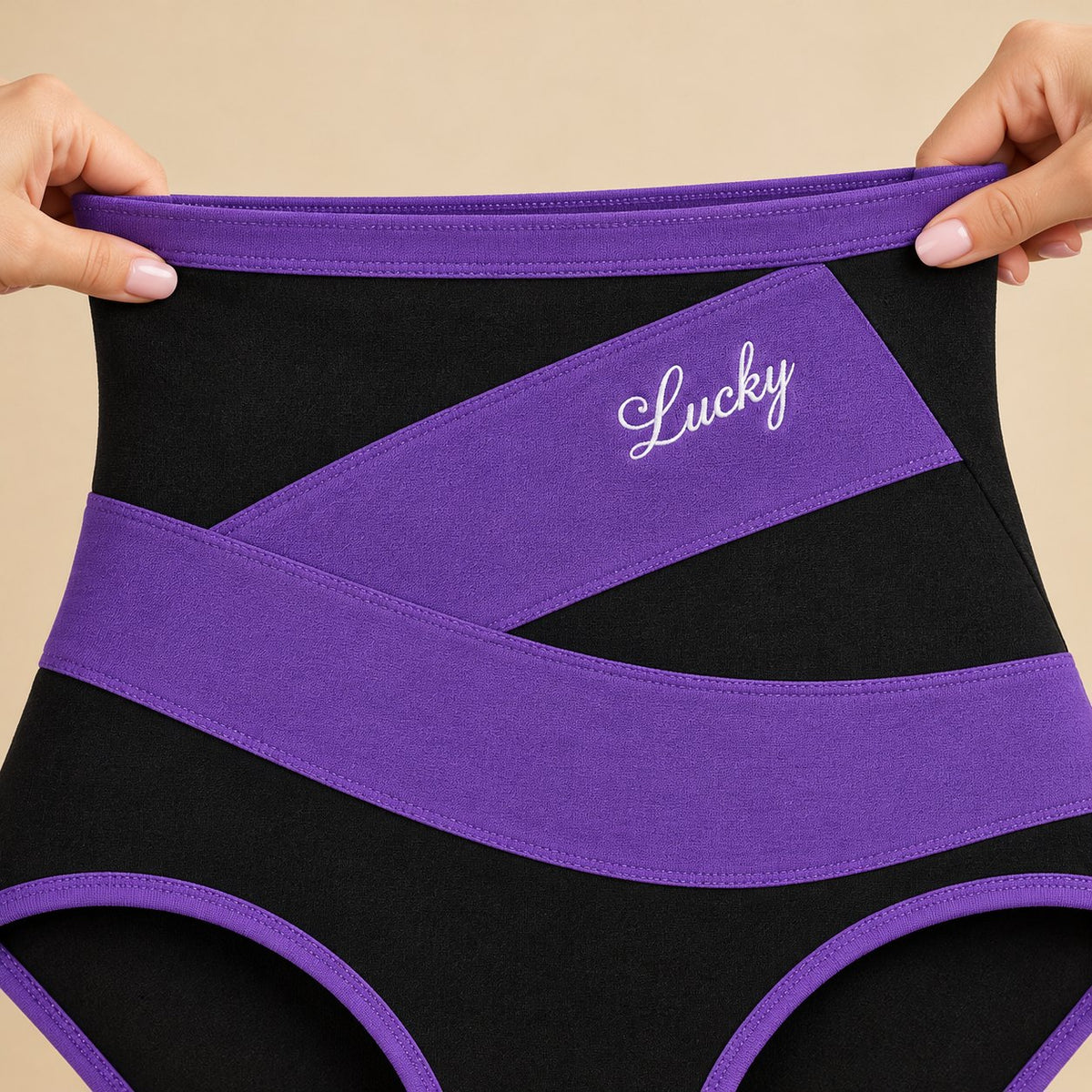 Hands stretching the wide high waistband of a purple-band brief