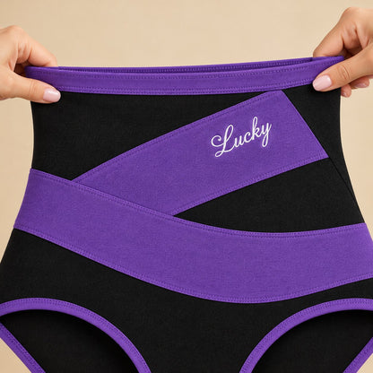 Hands stretching the wide high waistband of a purple-band brief