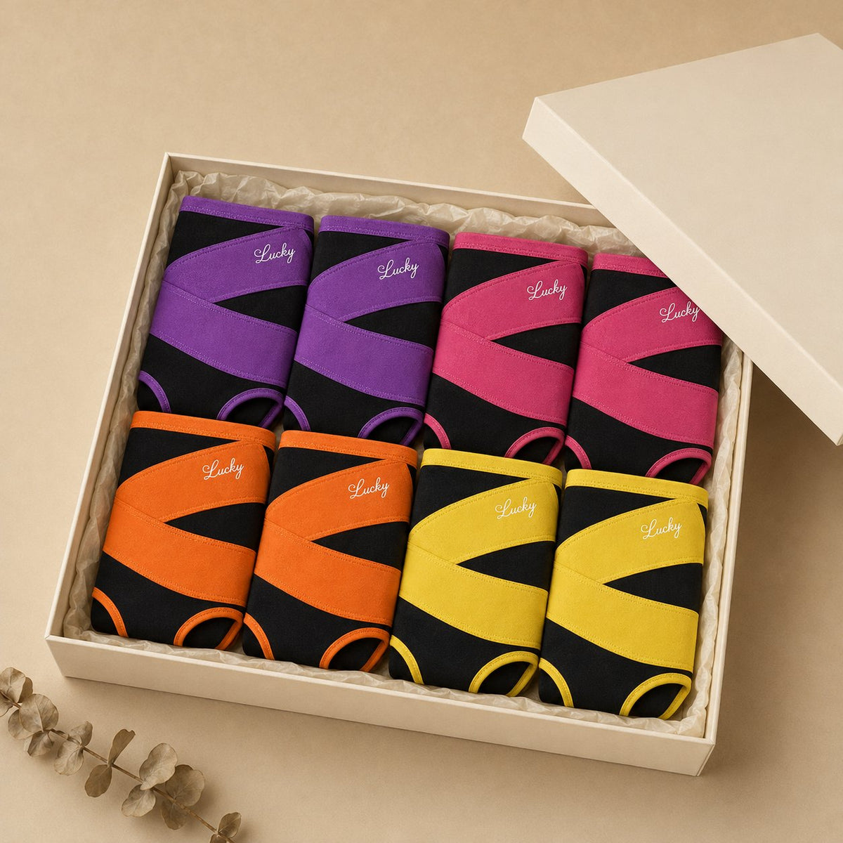 The 8-pack of shaping briefs folded in an open cream gift box