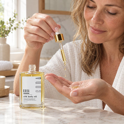 Putting a few drops of Silk Body Oil into the palm