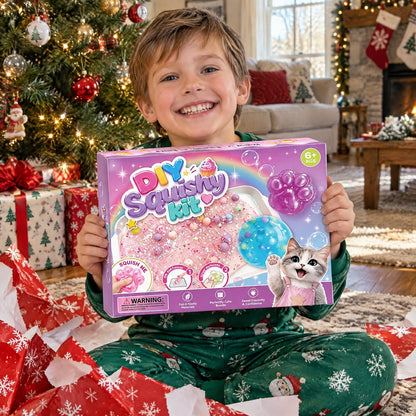 Boy holding up the DIY Squishy Kit box by the Christmas tree