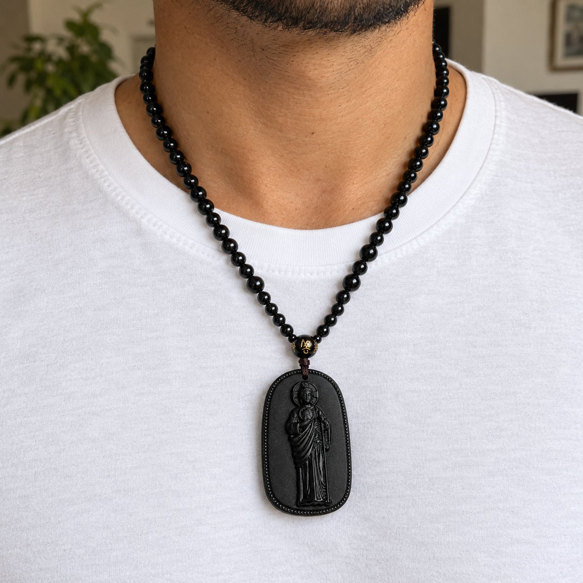 Wearing the San Judas Tadeo necklace over a white t-shirt
