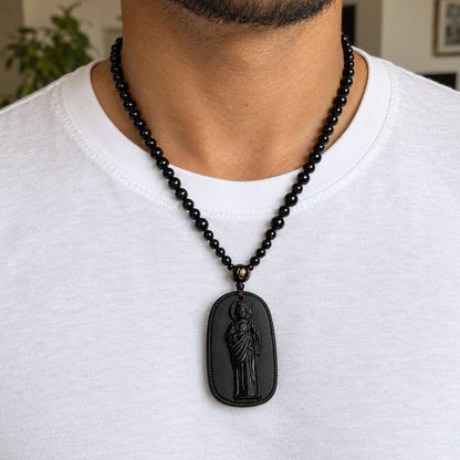 Wearing the San Judas Tadeo necklace over a white t-shirt
