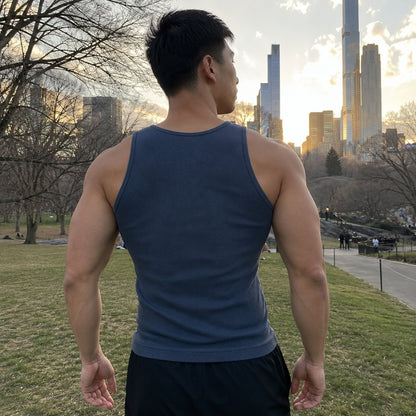 Back view of the steel blue tank: wide straps over the shoulders and a wide back panel that covers the shoulder blades