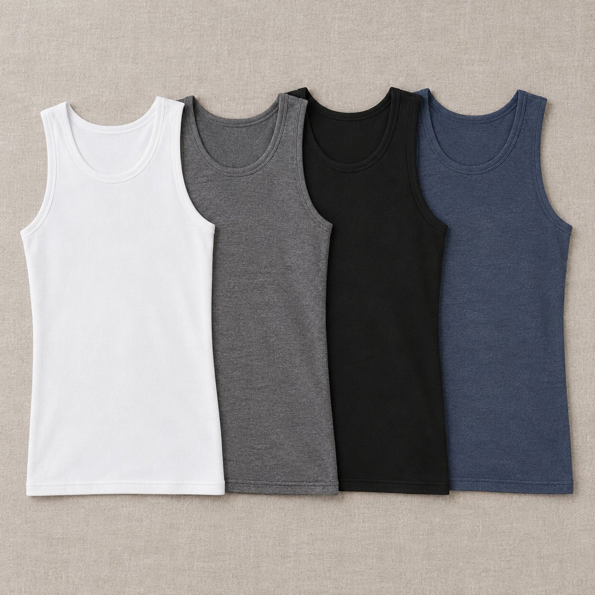 The fitted ribbed tank in its 4 colors laid flat: white, grey, black and steel blue