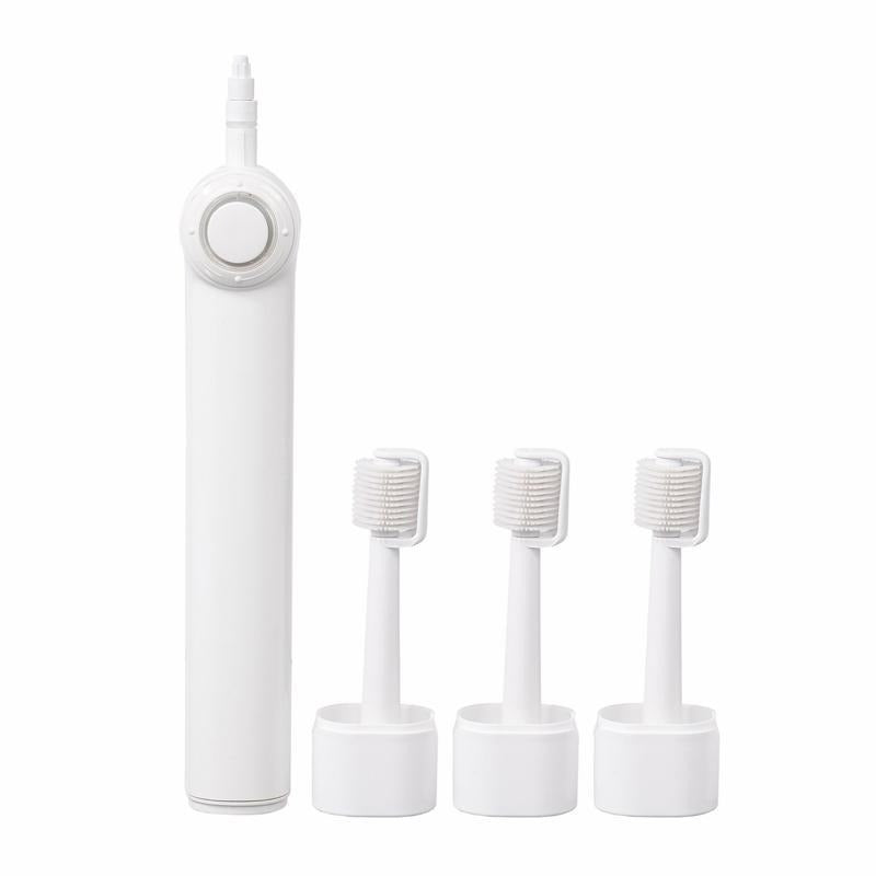 White electric toothbrush handle with a round button, next to three silicone roller heads standing in their holders