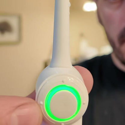 Close-up of the toothbrush button with its light ring glowing green