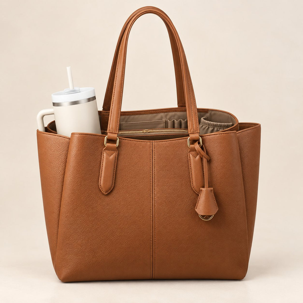 Everyday Organizer Tote in cognac brown pebbled faux leather with a 40 oz tumbler tucked in the side
