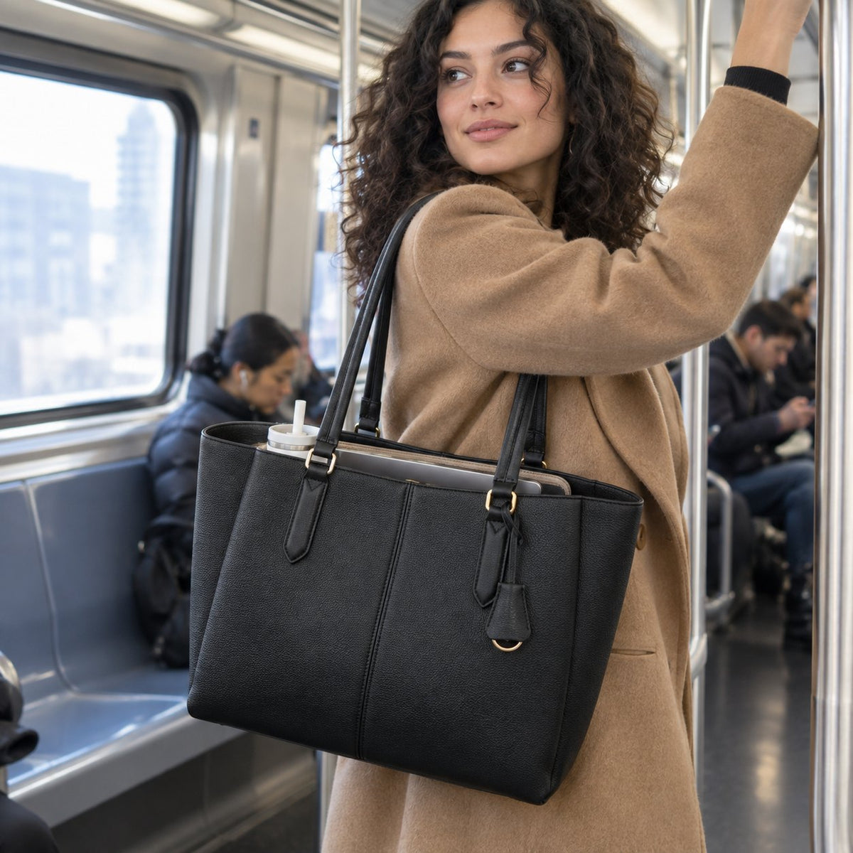 Woman on the subway with the black organizer tote on her shoulder