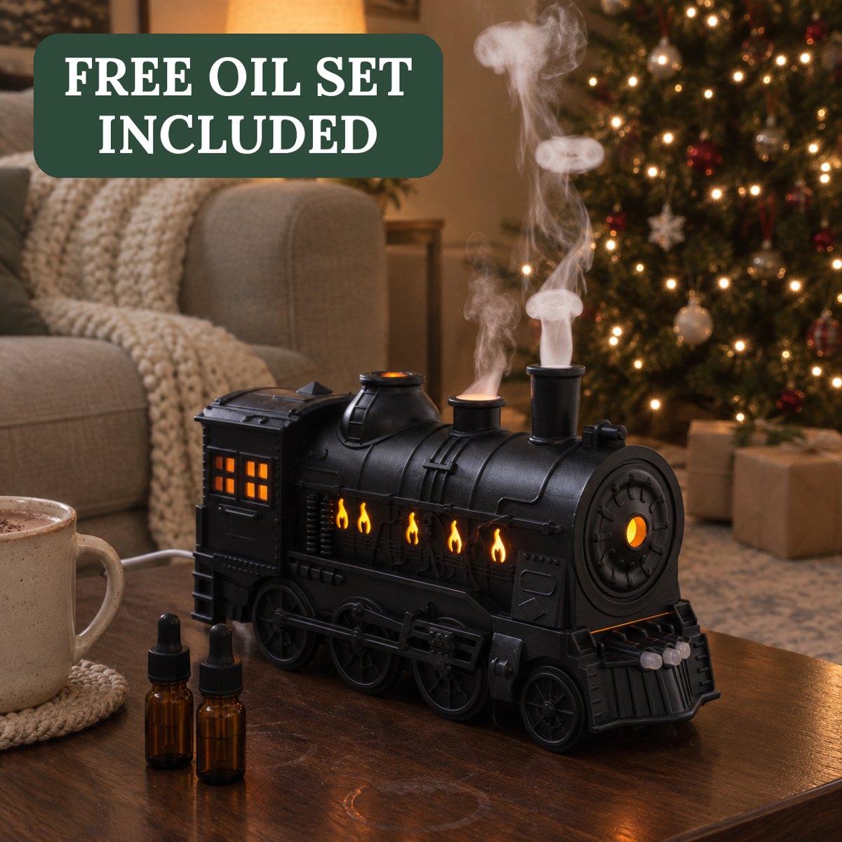 Black vintage steam train diffuser glowing amber and puffing scented mist on a side table next to a Christmas tree, with two small oil bottles