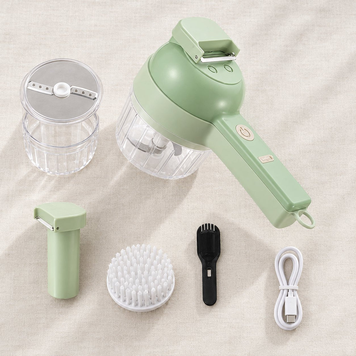 Everything in the box laid out: motor handle, bowl, slicer, pusher, brush, spatula, USB-C cable