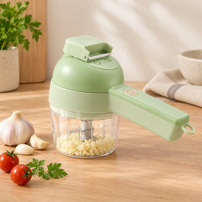 Mint green cordless vegetable cutter with its chopping bowl full of minced garlic on a kitchen counter